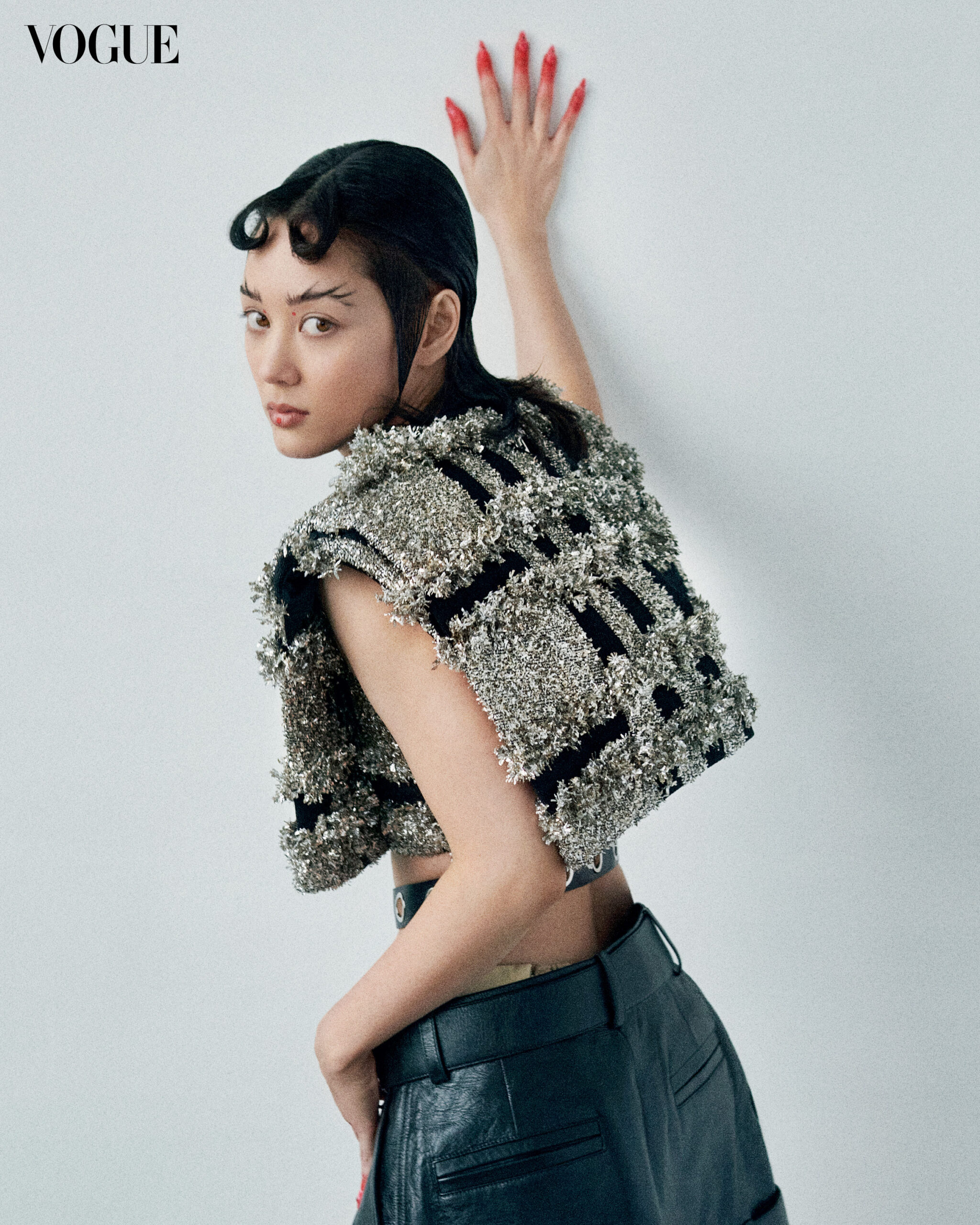 LOUIS VUITTON top, belt, and pants. REPOSSI earrings styled by Melissa Levy