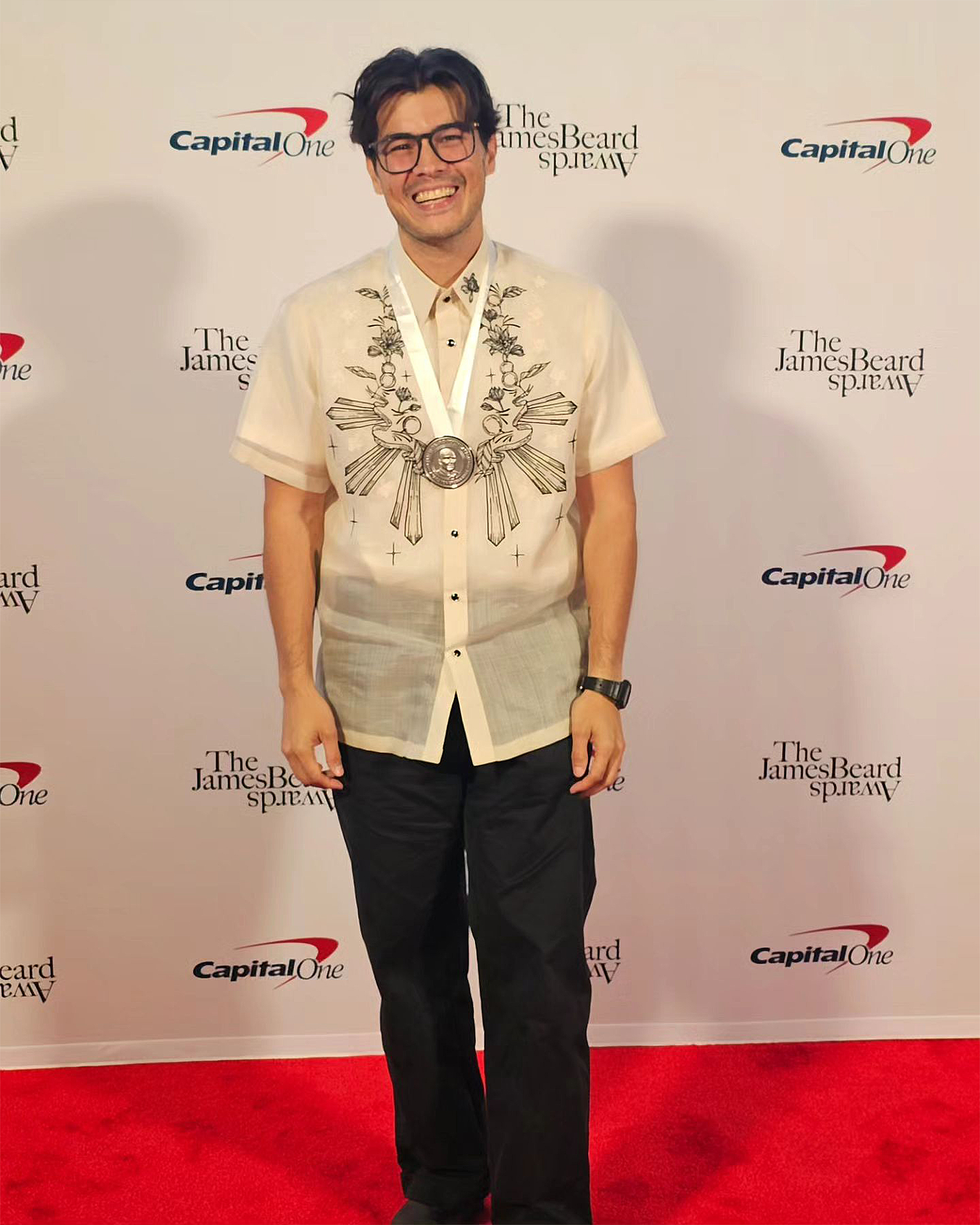Erwan Heussaff wearing his James Beard Award.