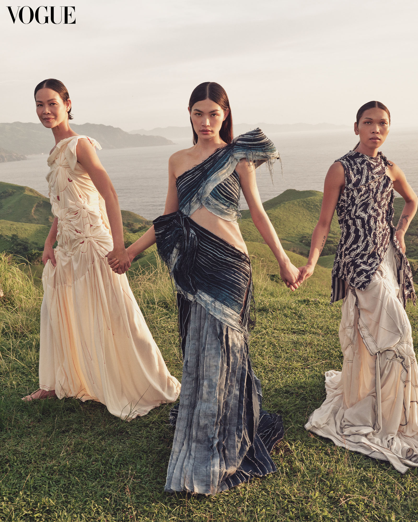 This FRANCIS LIBIRAN dress worn by Rina is crafted with scraps of denim, while the CARL JAN CRUZ Flower Ikot gown worn by Jo Ann showcases its fauna-shaped quilts created from hand twisting pique fabric. On Lukresia, the CARL JAN CRUZ Istatwa Siksik top is draped to hug the body and the Kwarto Ikot dress is worn as a skirt. All wear Ivatan Tukap sandals.