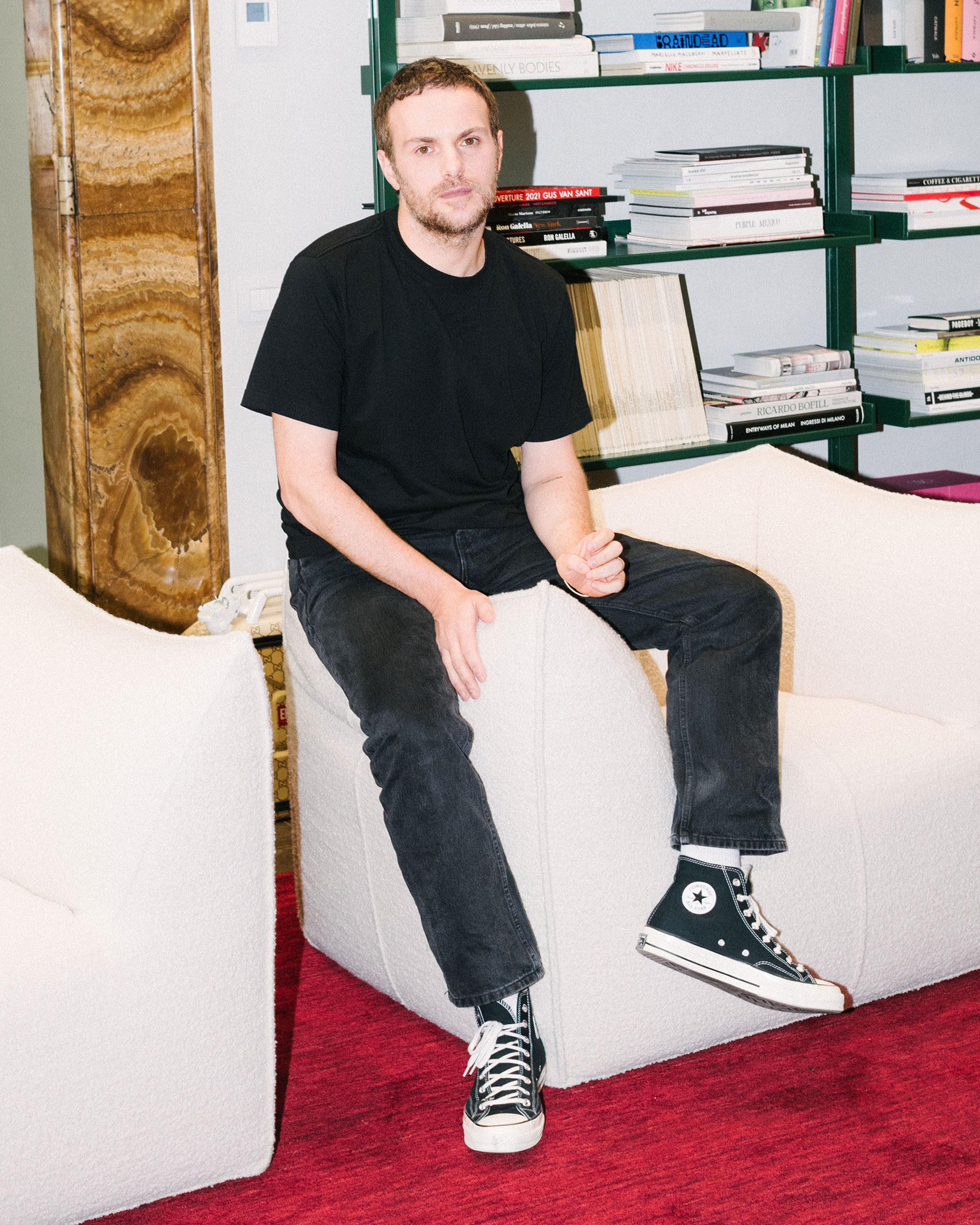 Sabato de Sarnos office is filled with books art and four Mario Bellini Le Bambole chairs.