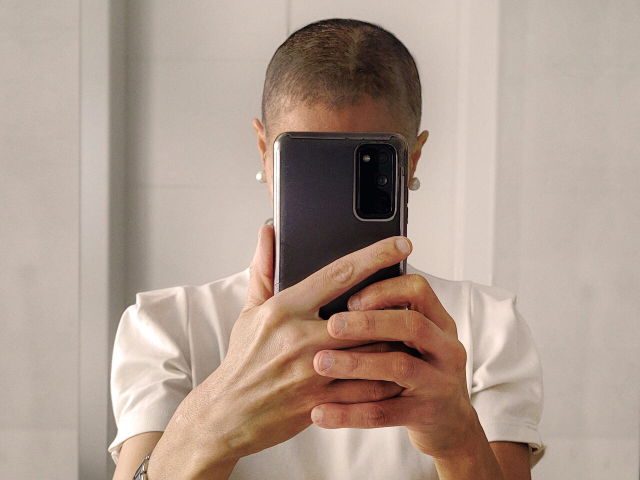 A woman taking a photo of herself in front of the mirror