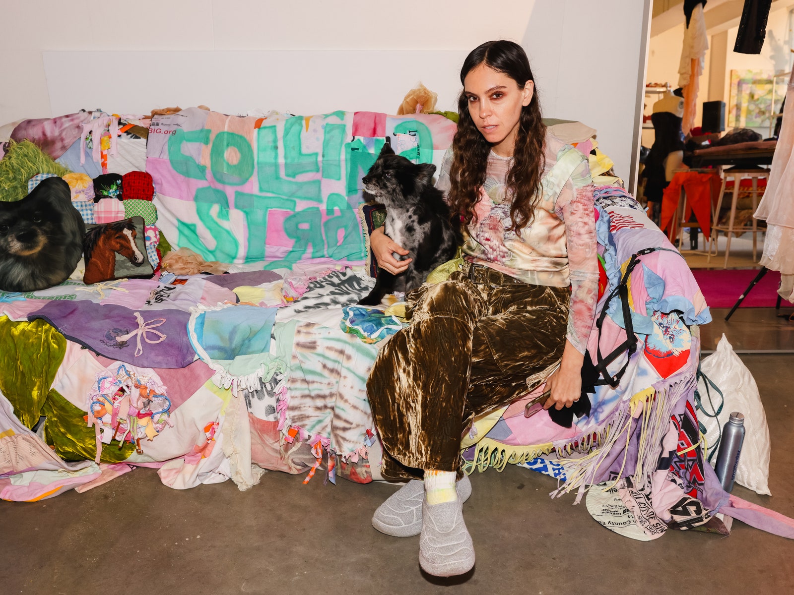 Hillary Taymour inside a studio sitting on a couch
