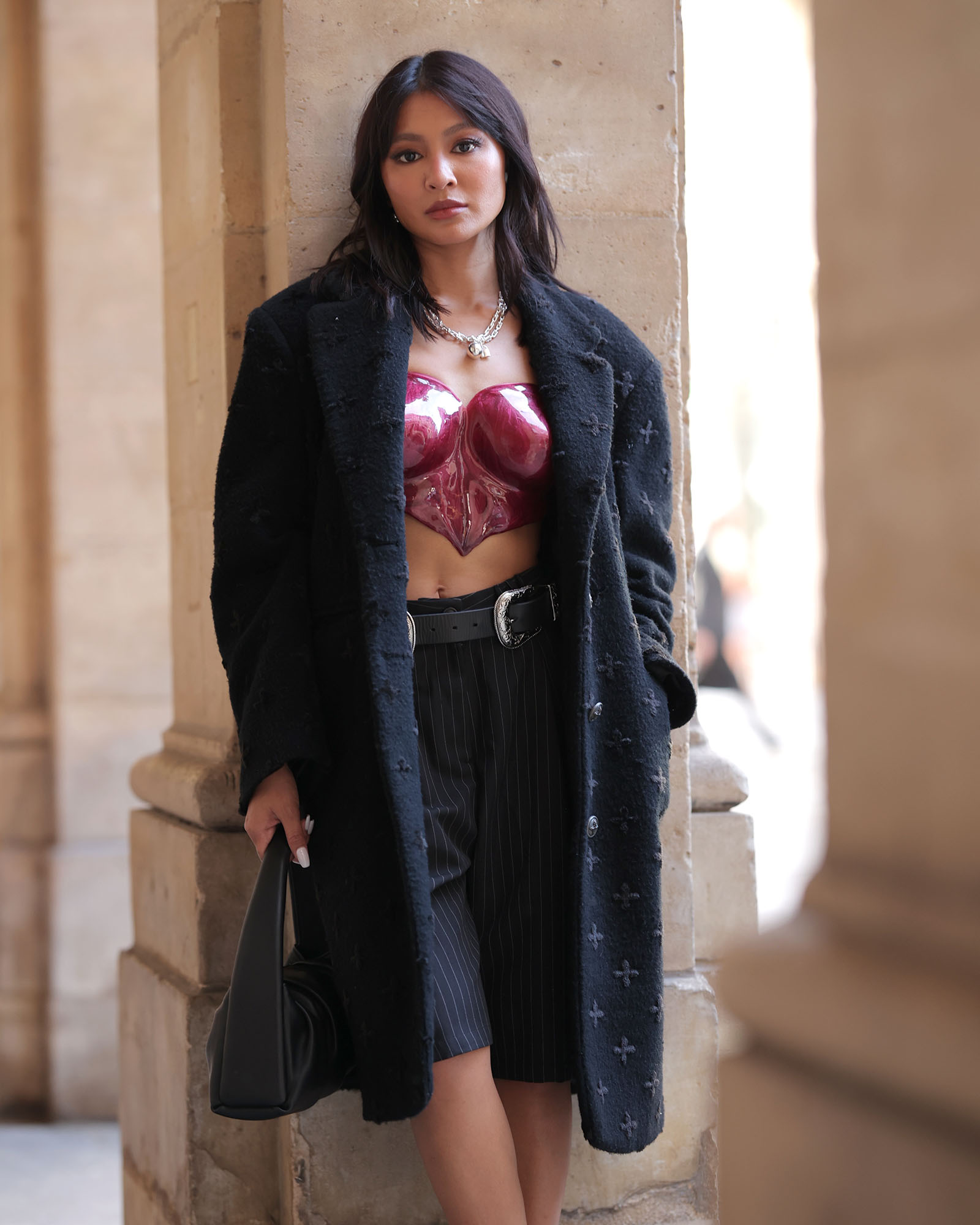 Nadine Lustre wears a Jacques The Label breastplate, SMFK black coat, and Tiffany & Co. jewelry.