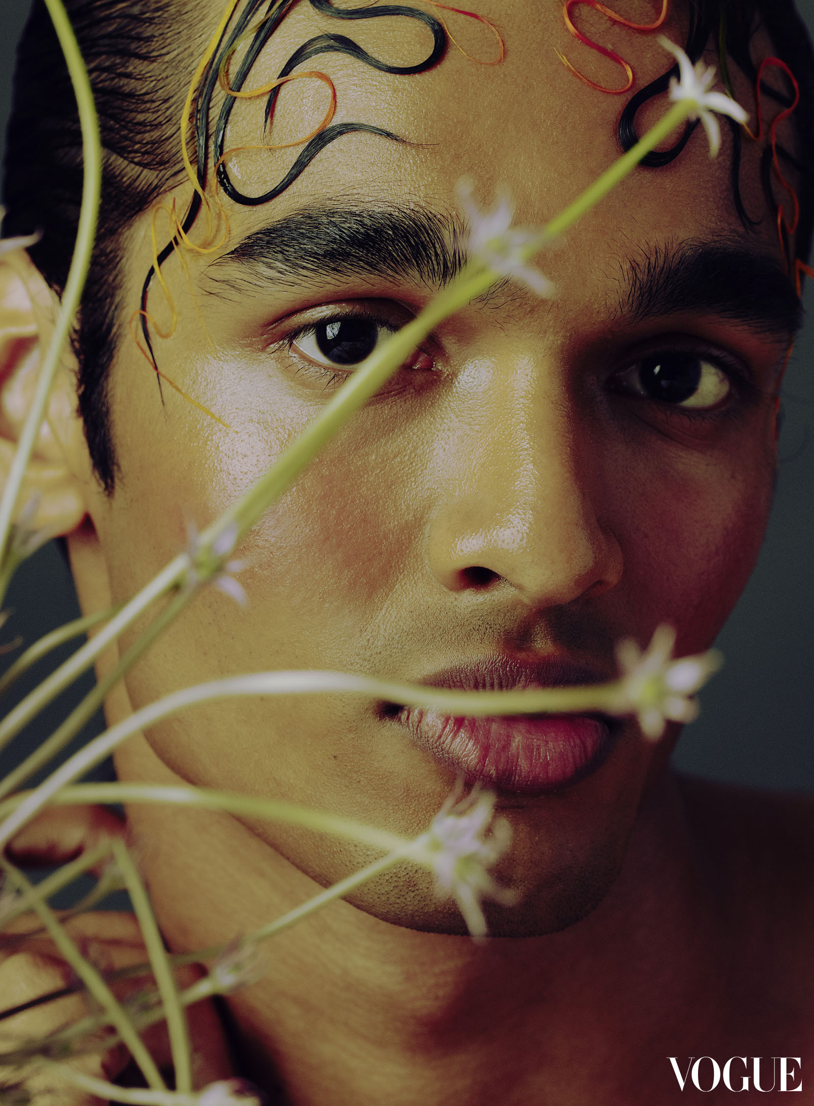 Model’s face framed with flowers photographed by Harold Julian.