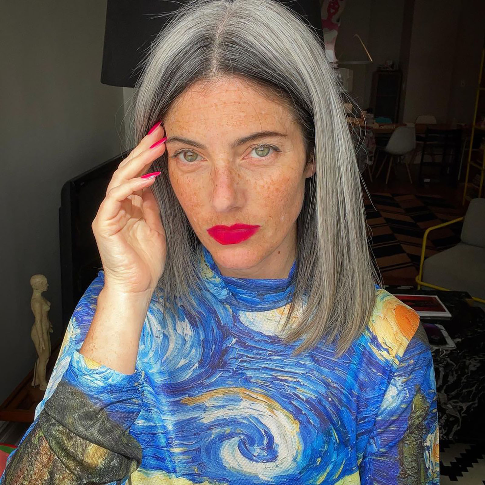A woman with a Vincent Van Gogh top and grey hair