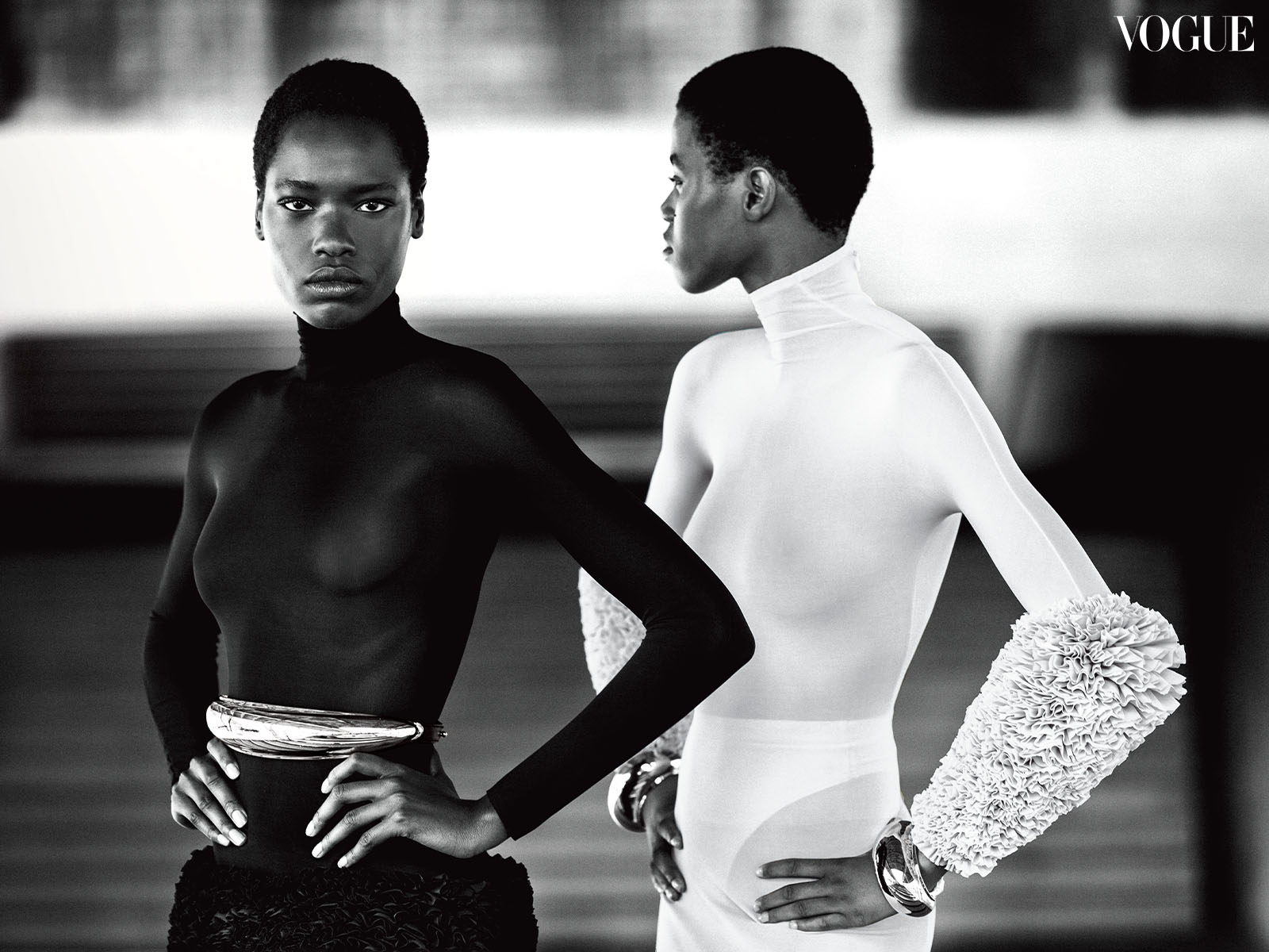 Model Awar Odhiang wearing an Alaïa dress and belt. Model Victoria Fawole wears an Alaïa dress and cuffs.