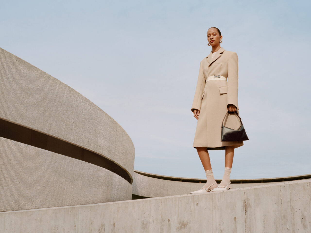 Selena Forrest wearing a beige trench coat from Mango's Selection collection