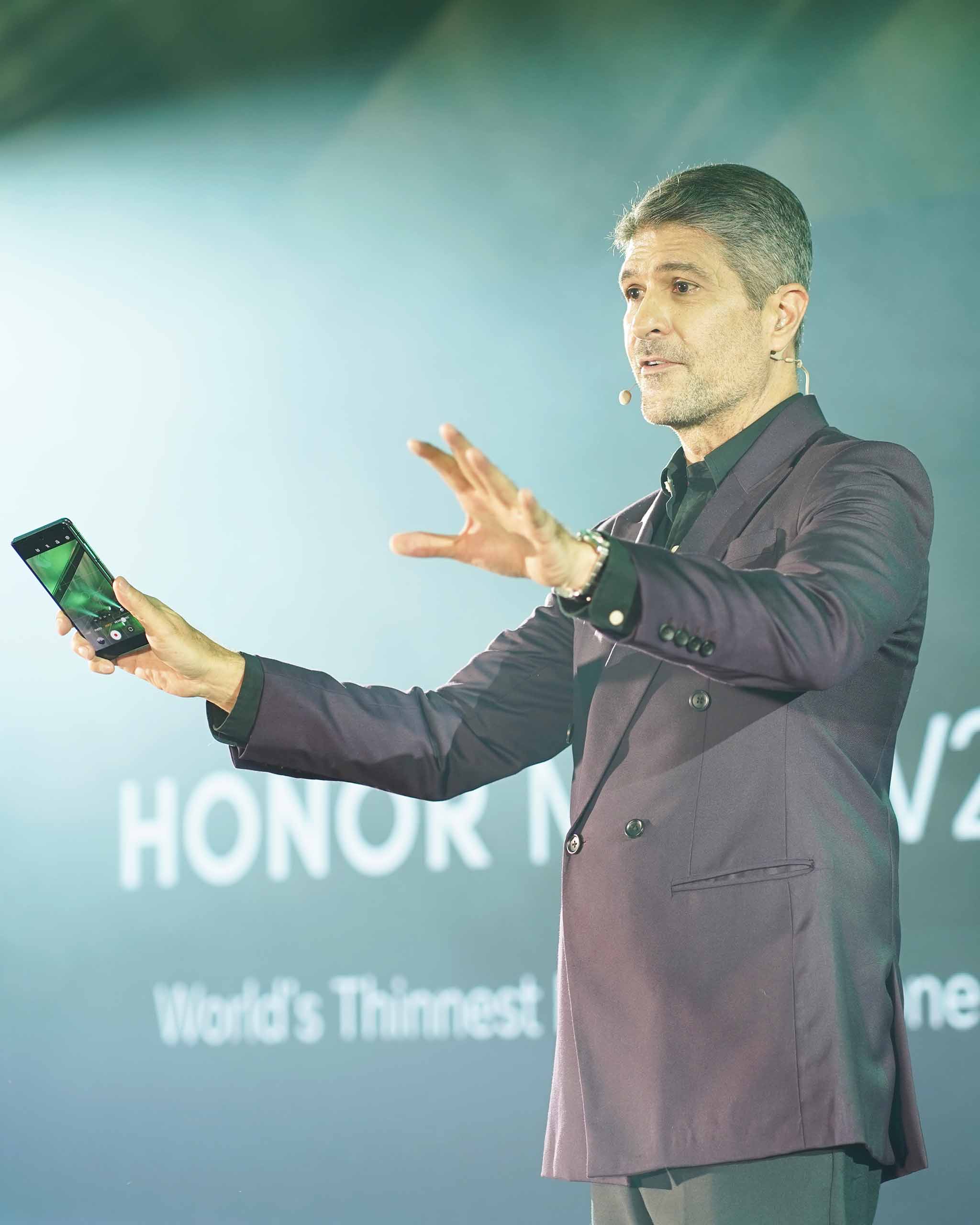 Host James Deakin wearing a plum suit to match the color of the HONOR Magic V2