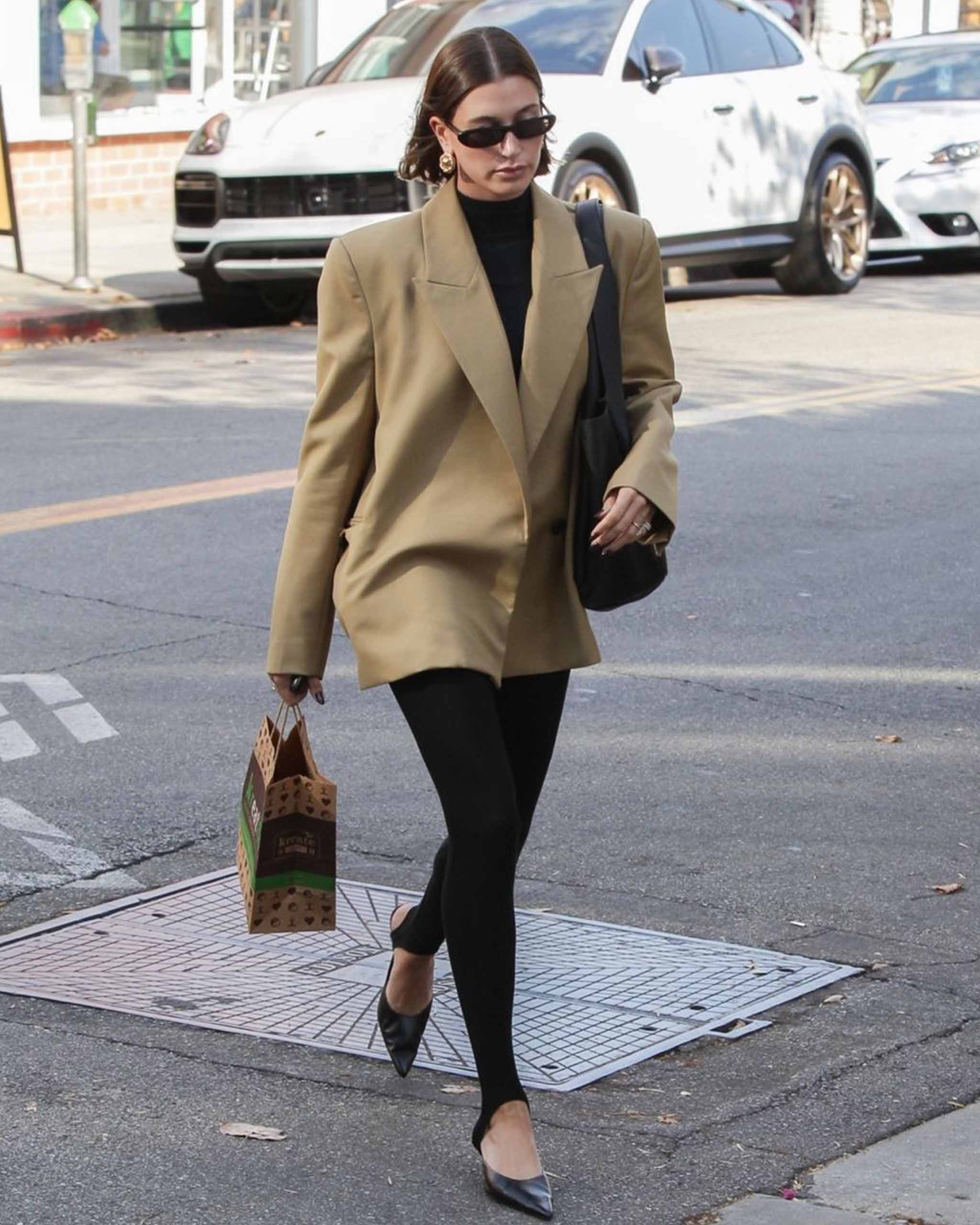 Hailey Bieber walking on the streets of Los Angeles with a black Saint Laurent tote