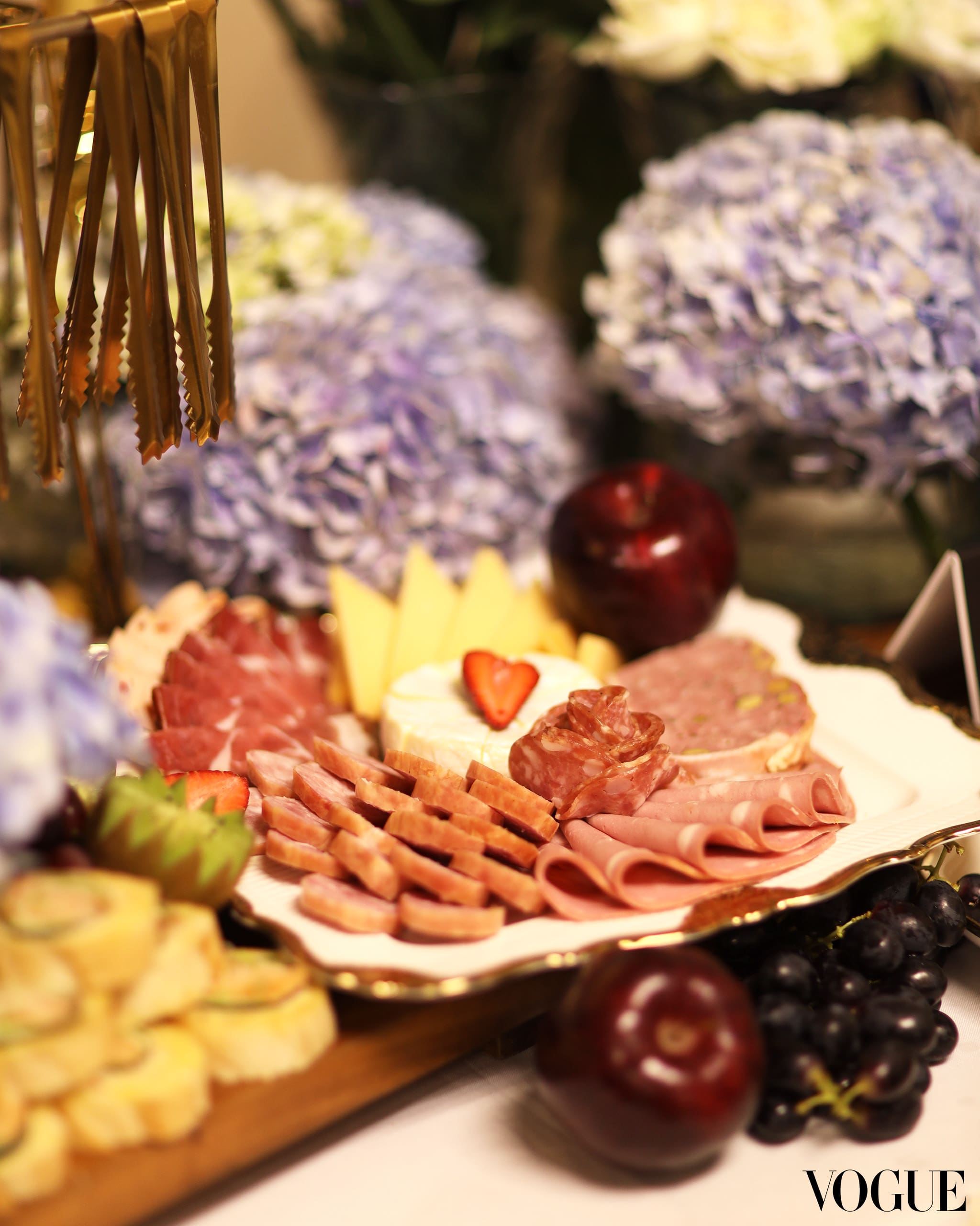 1 | vogue philippines Goodness Graze’s table with assorted charcuterie, cheeses, and fruits, surrounded by fresh flowers. Photo by Ed Simon.