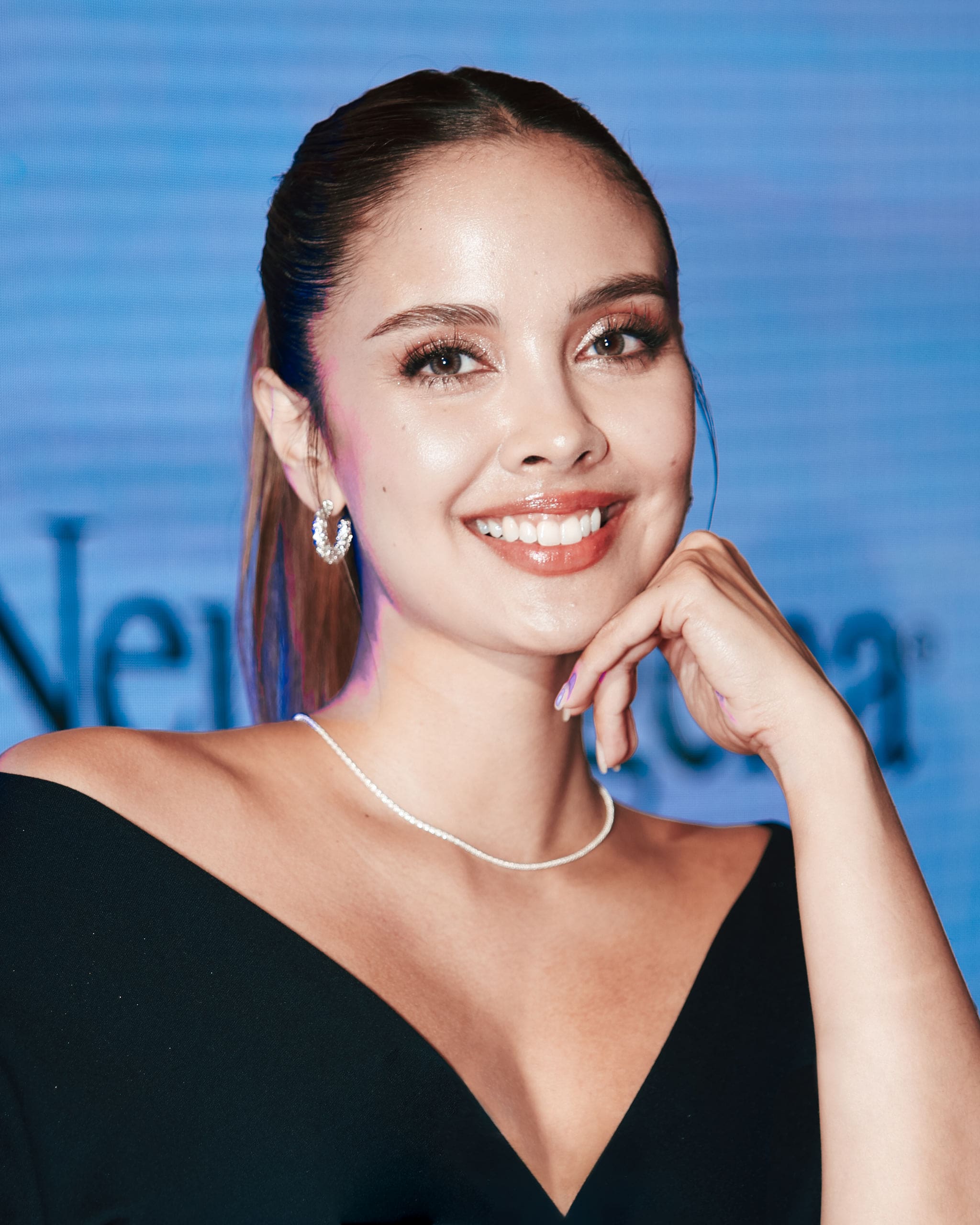 Megan Young wearing a black dress and diamond jewelry at the Neutrogena Visible Repair launch