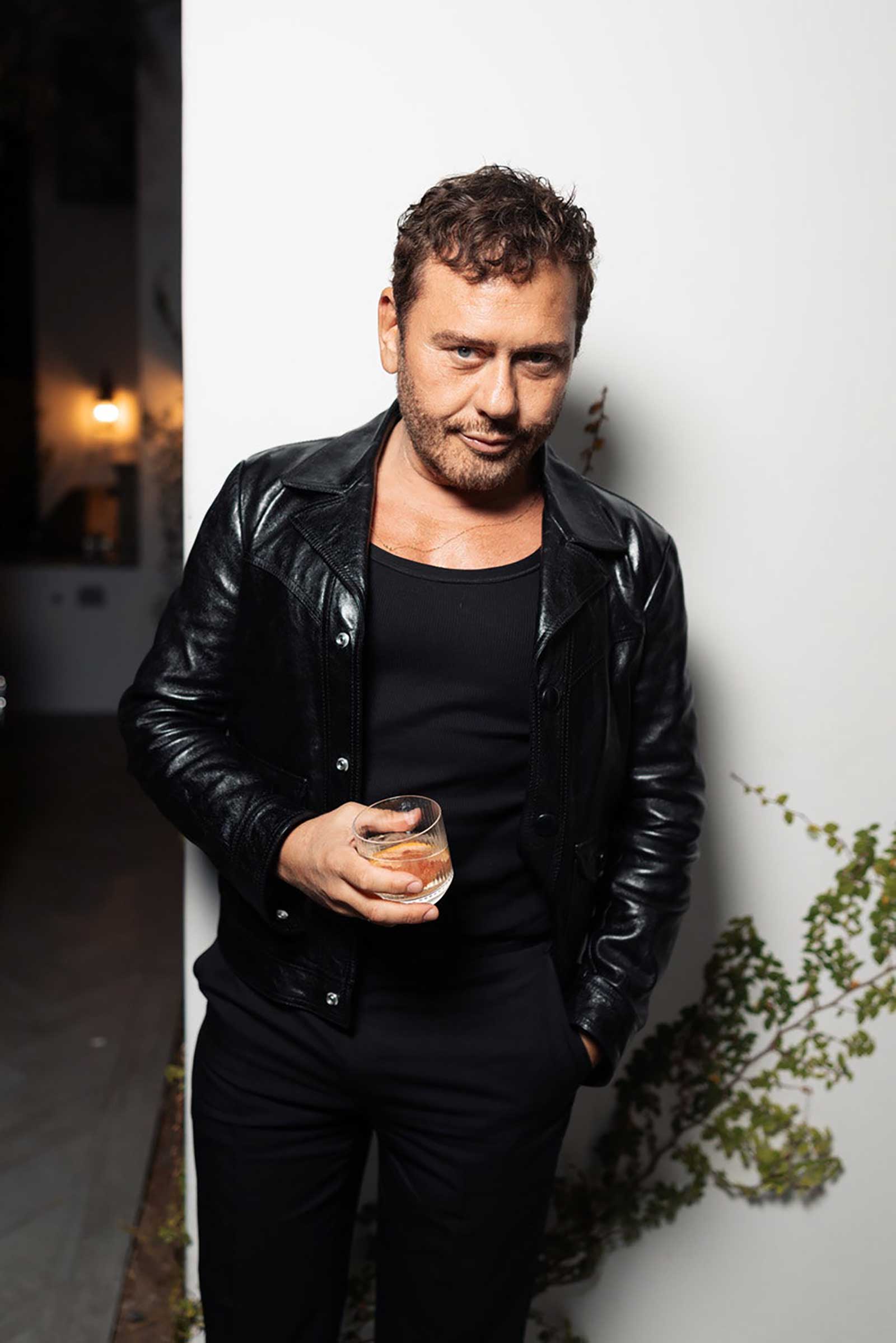 A photo of a person holding a drink in hand at a Golden Globes afterparty.