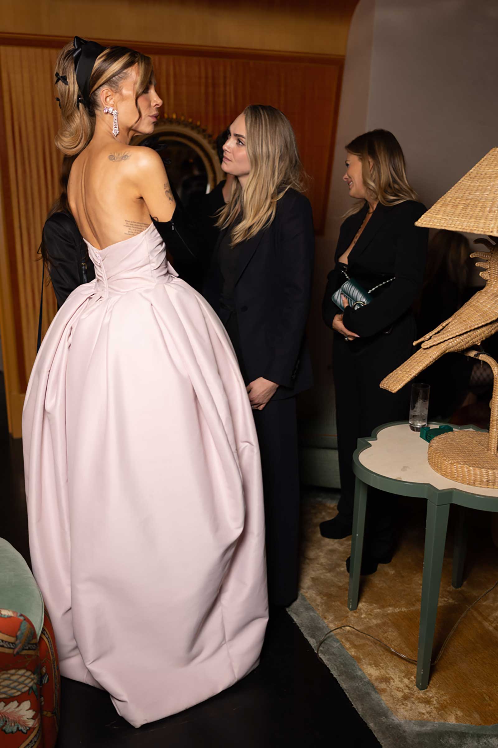 A photo of Kate Beckinsale, in a plum ball gown, and model-actress Cara Delevingne.