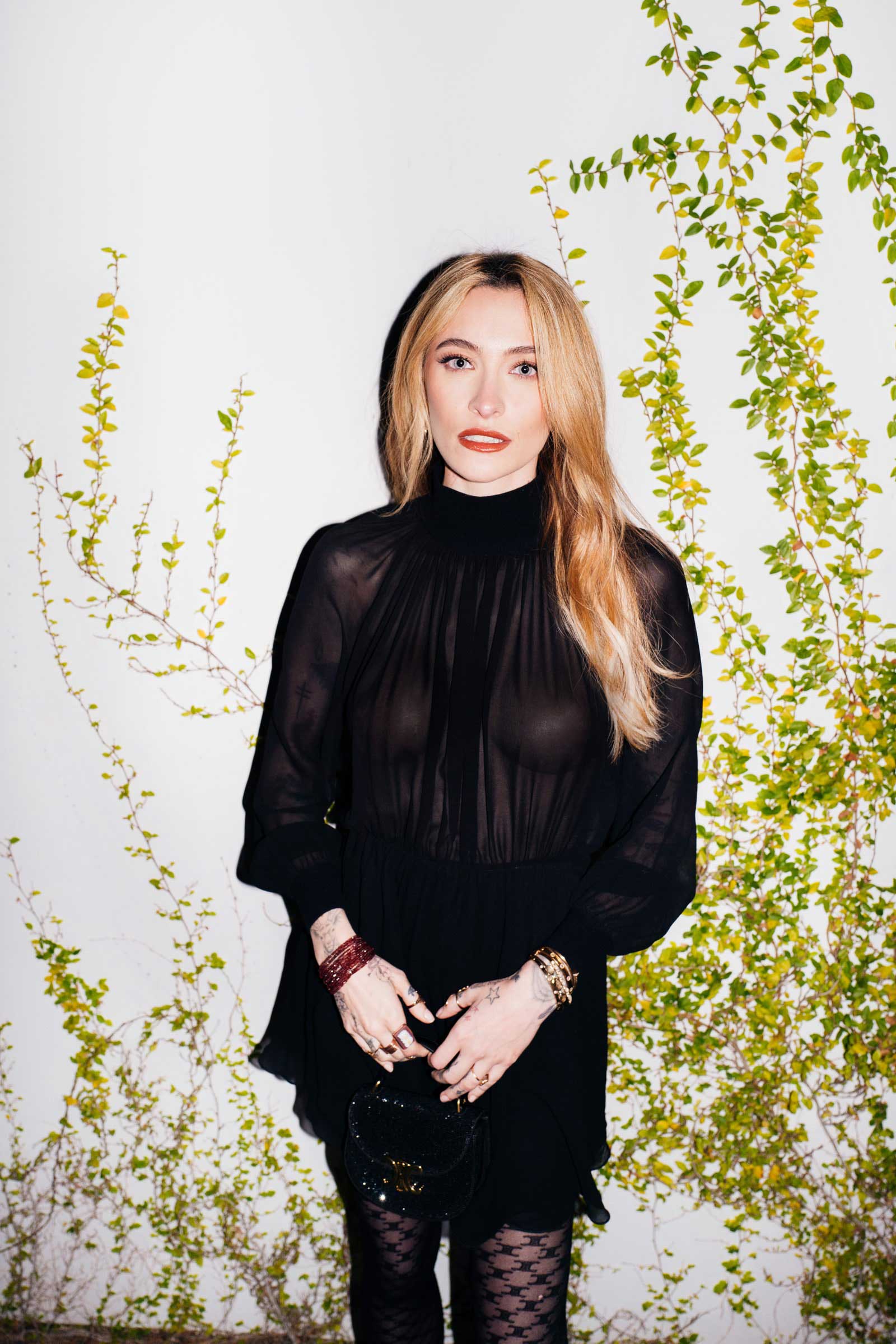 A photo of Paris Jackson in a sheer top and mesh tights at a Golden Globes afterparty.