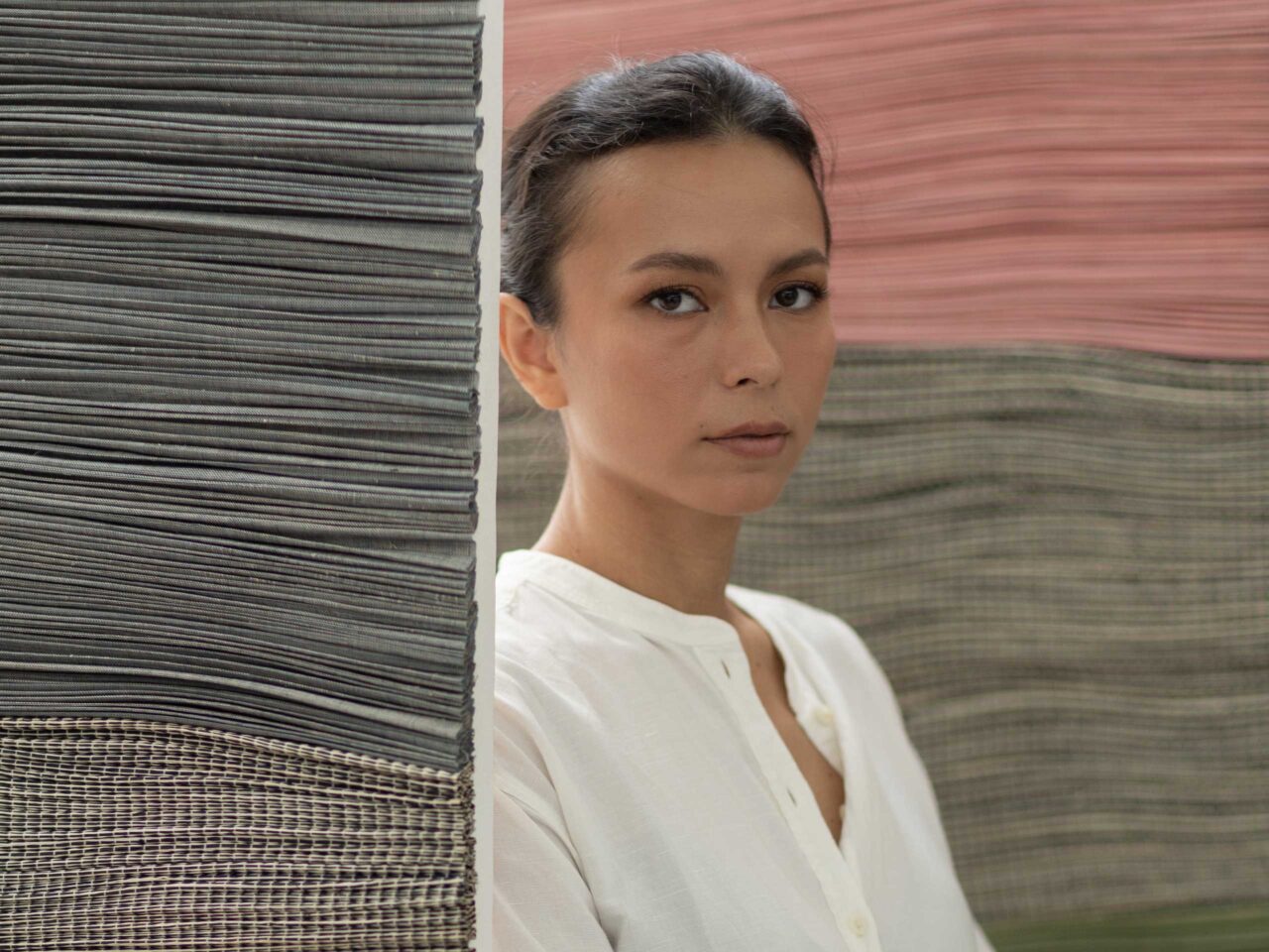 Artist Solenn Heusaff posed in front of her paintings.