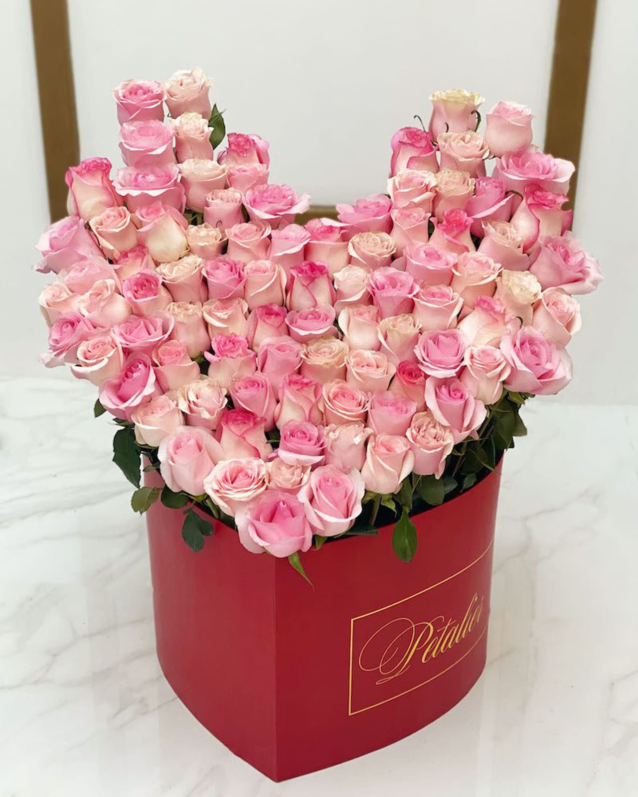 A heart-shaped bouquet of pink Ecuadorian roses