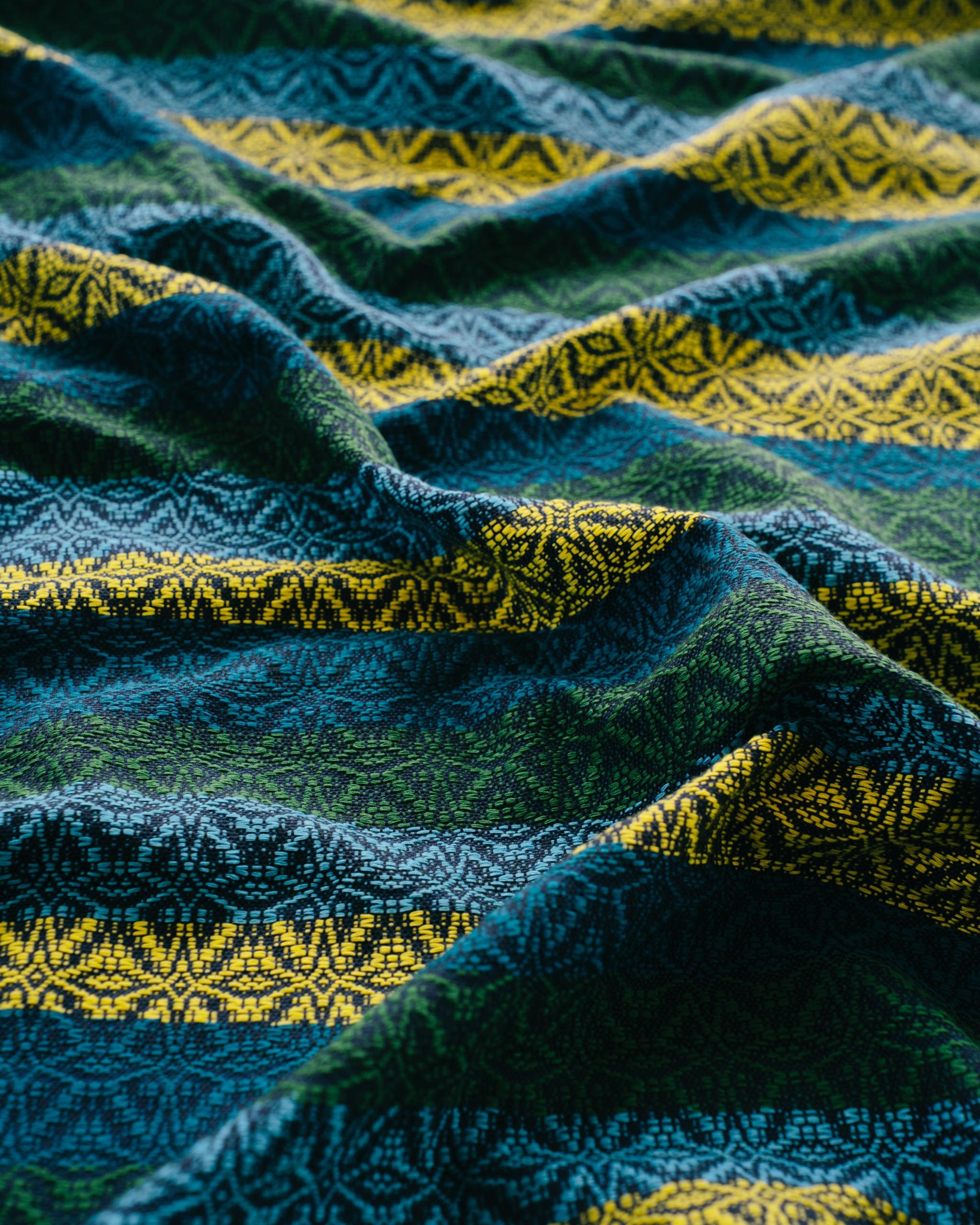 A weave pattern created by Iloilo's Baraclayan Weavers Association in Cebu Pacific's motif of blue, green, and yellow.