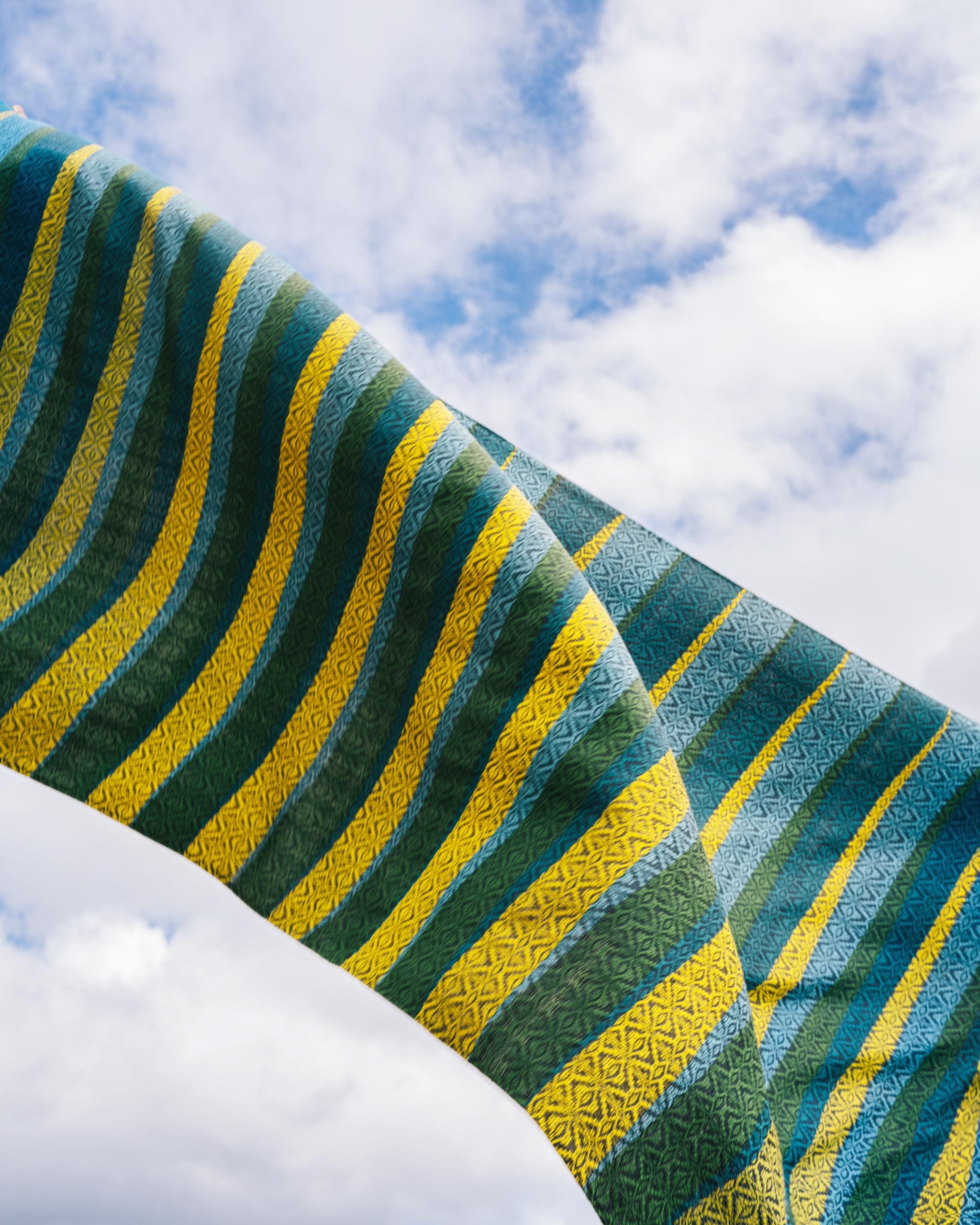 A weave pattern created by Iloilo's Baraclayan Weavers Association in Cebu Pacific's motif of blue, green, and yellow.