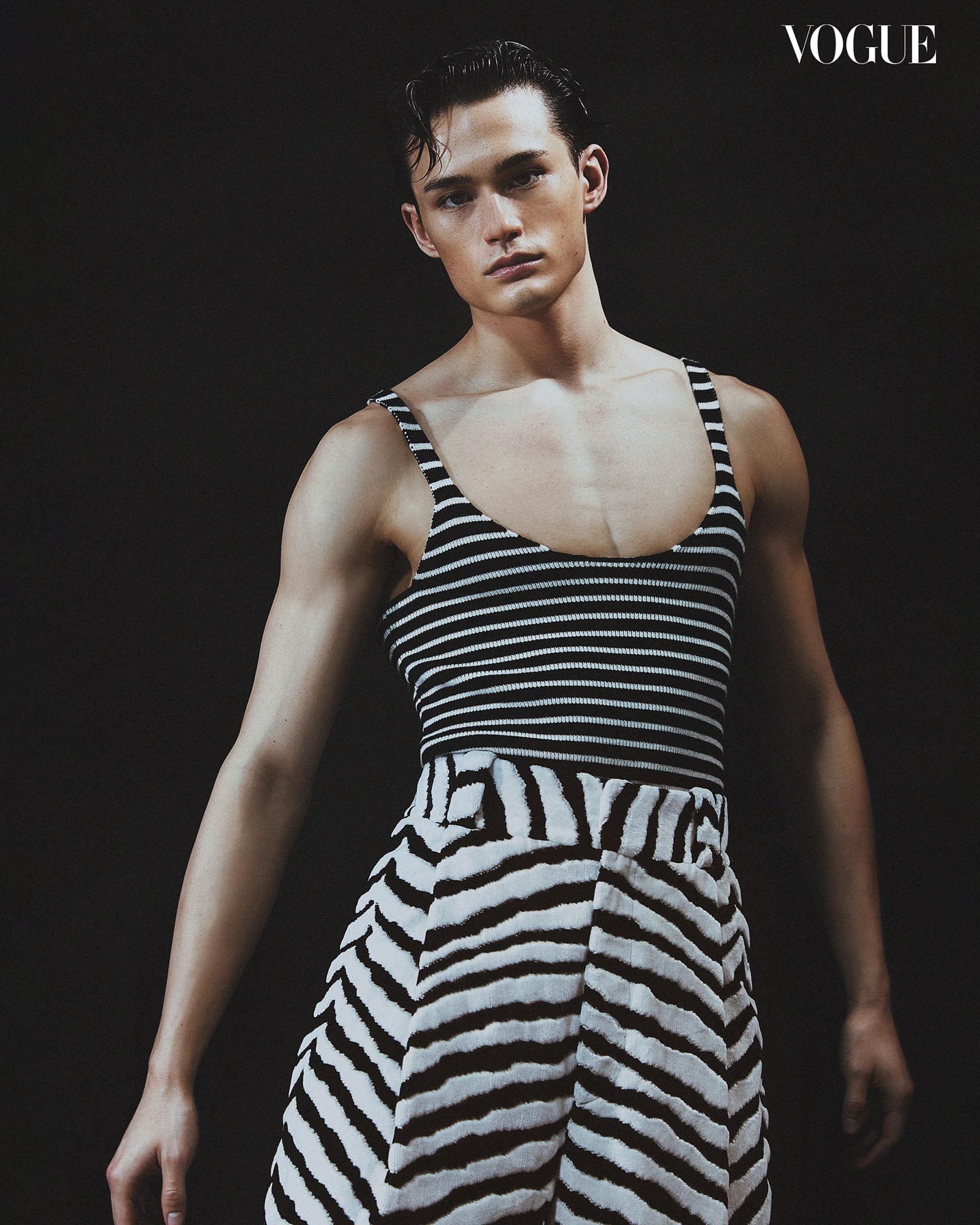 Alex Schlab sports a cropped striped top paired with coordinating striped trousers.