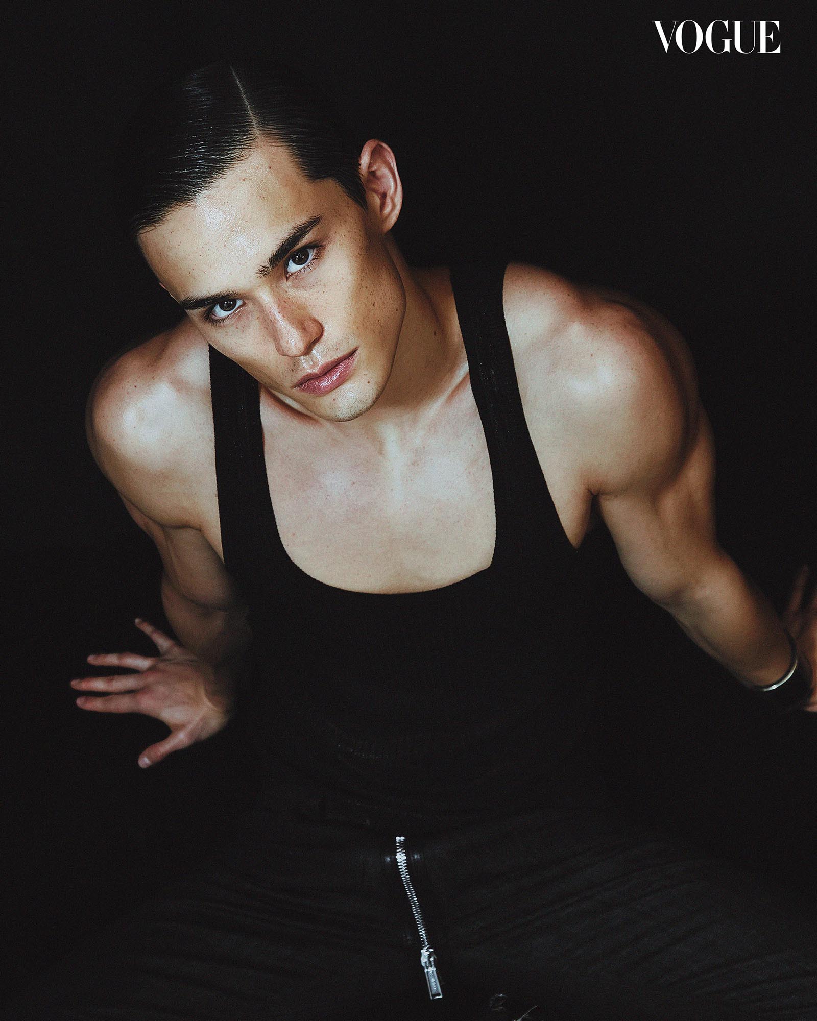 A top-down view of Alex Schlab in a monochrome black ensemble, his hair neatly slicked back.