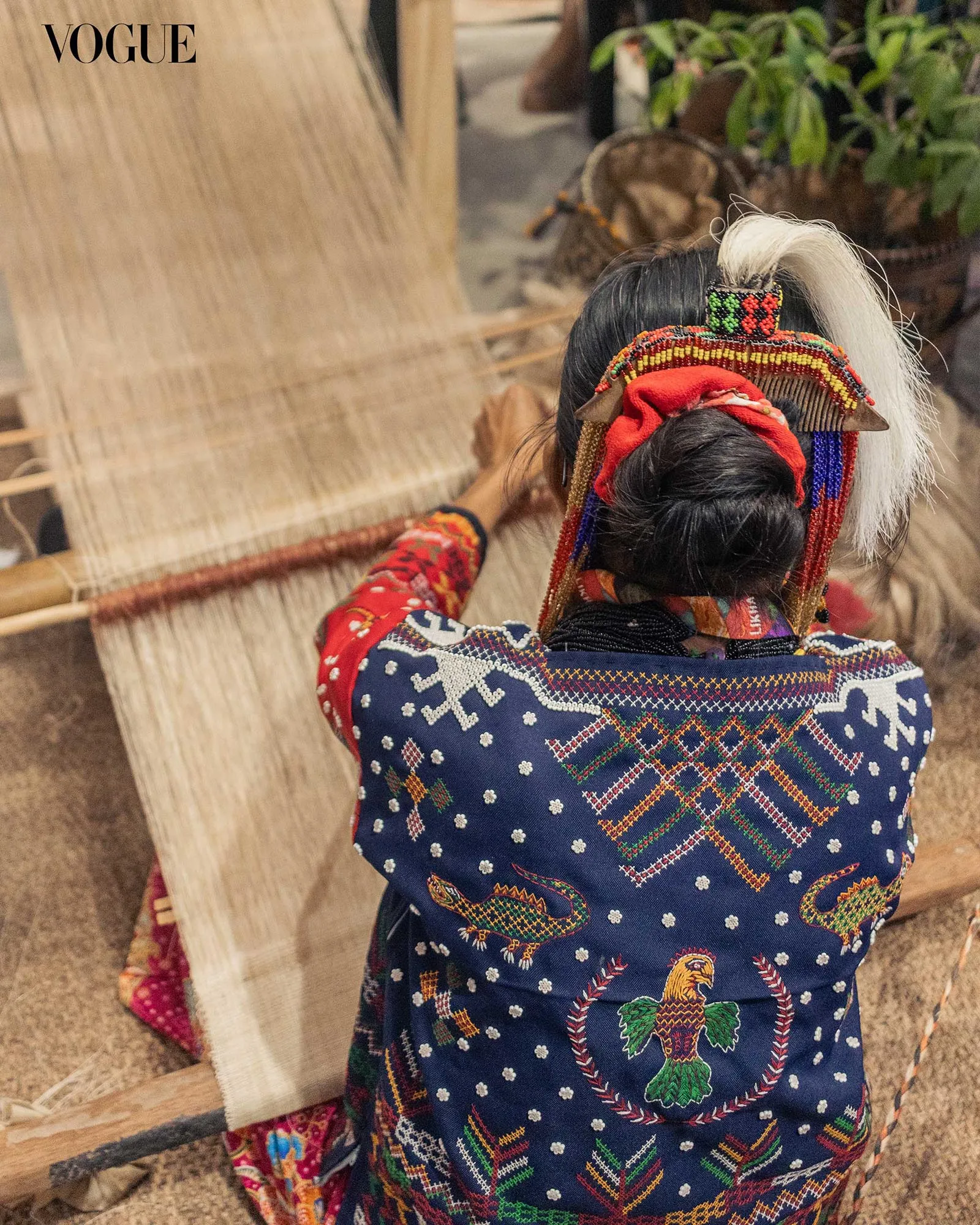 A weaver shows the process of creating indigenous textile