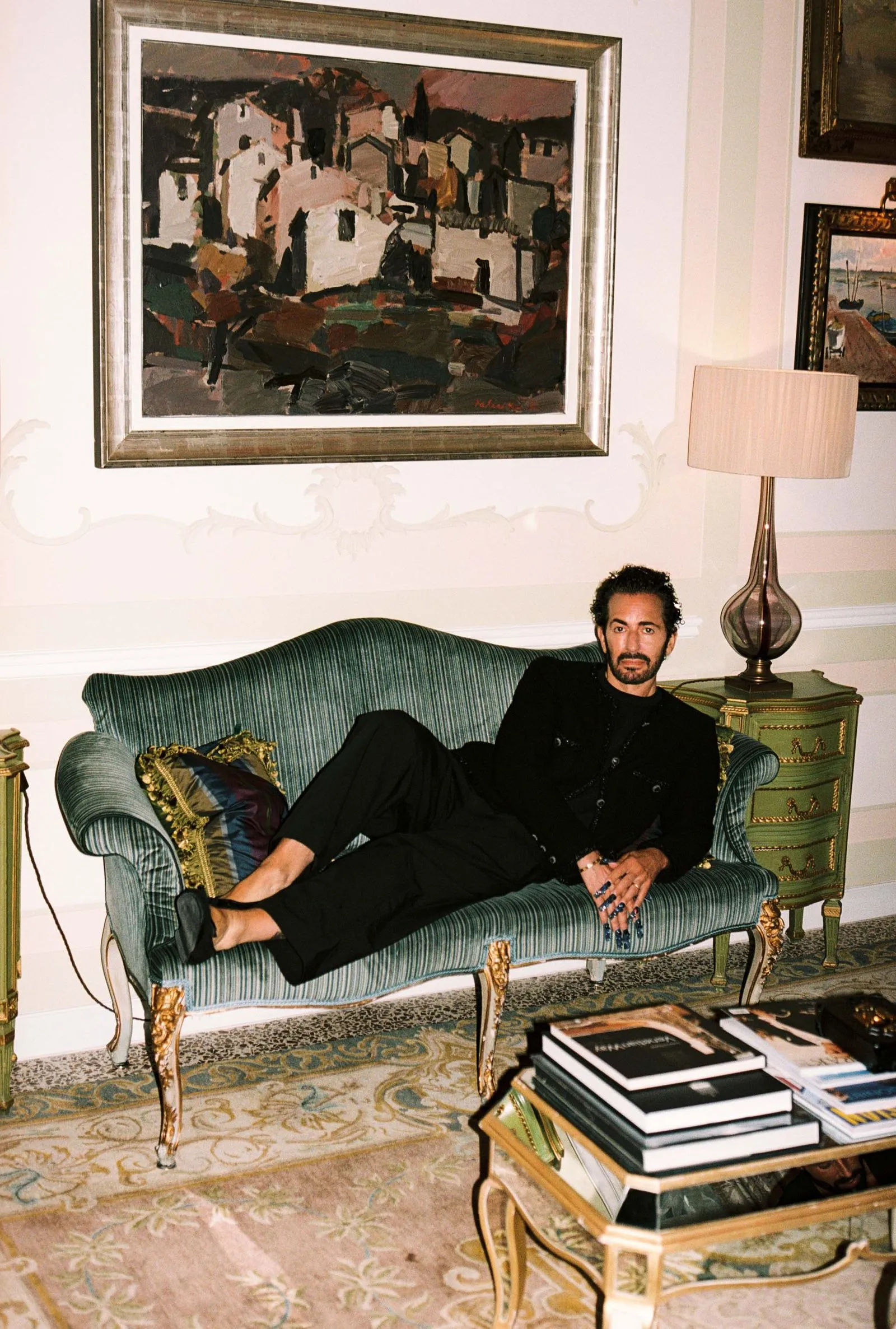 Designer Marc Jacobs lounges on a green sofa