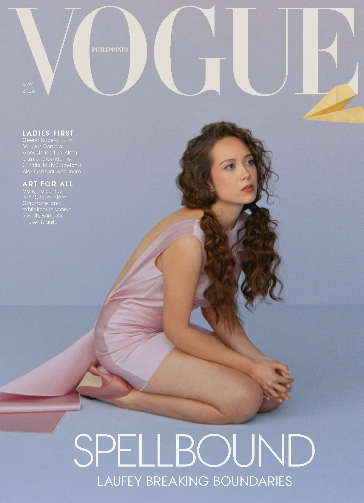 Vogue Philippines May 2026 cover: a woman in a pale pink dress sits on the floor against a lavender backdrop, with bold SPELLBOUND text at the bottom.