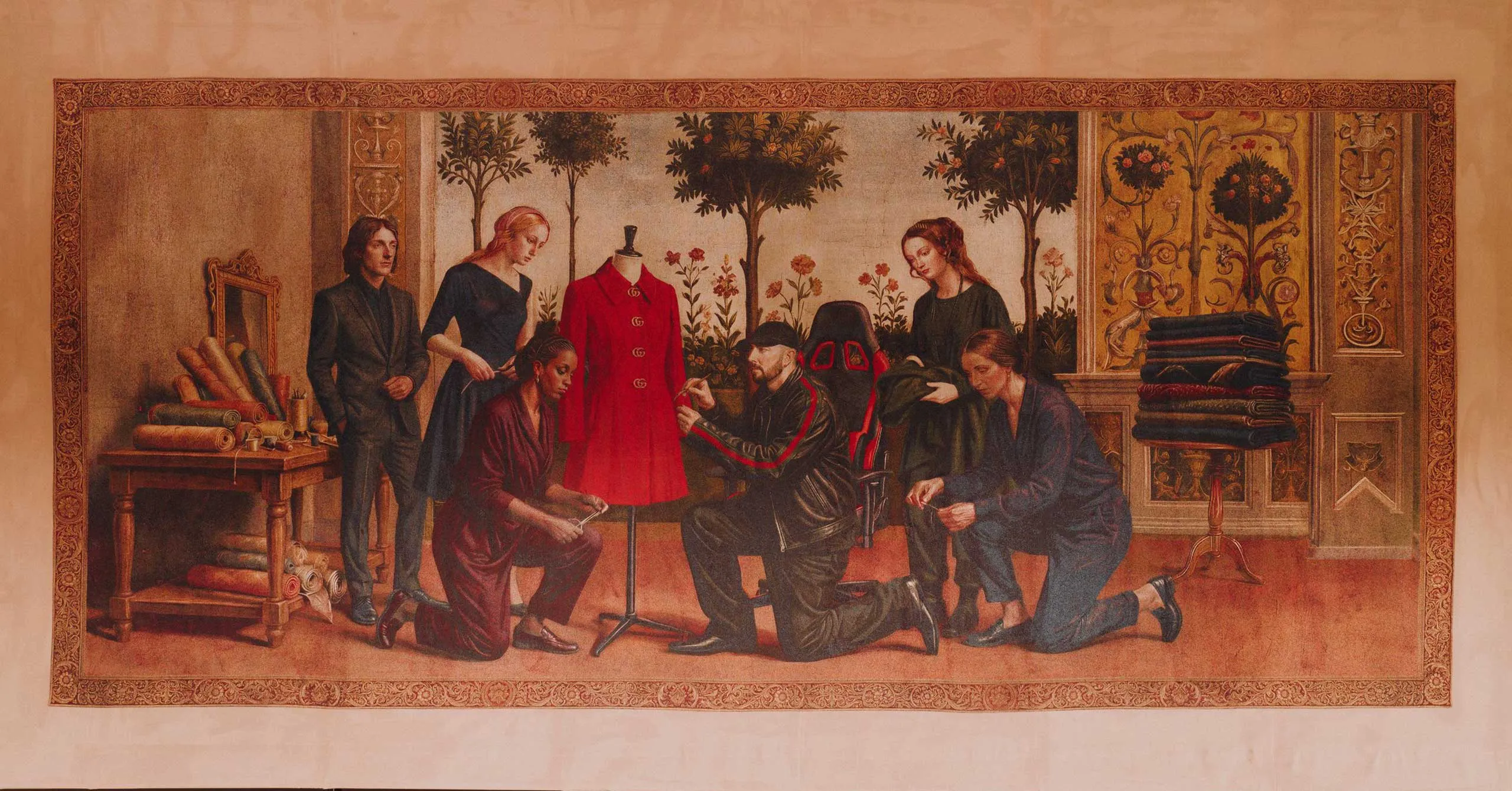 Group of people gathered around a red coat on a mannequin in a sewing workshop-like room with fabric rolls on a table nearby.