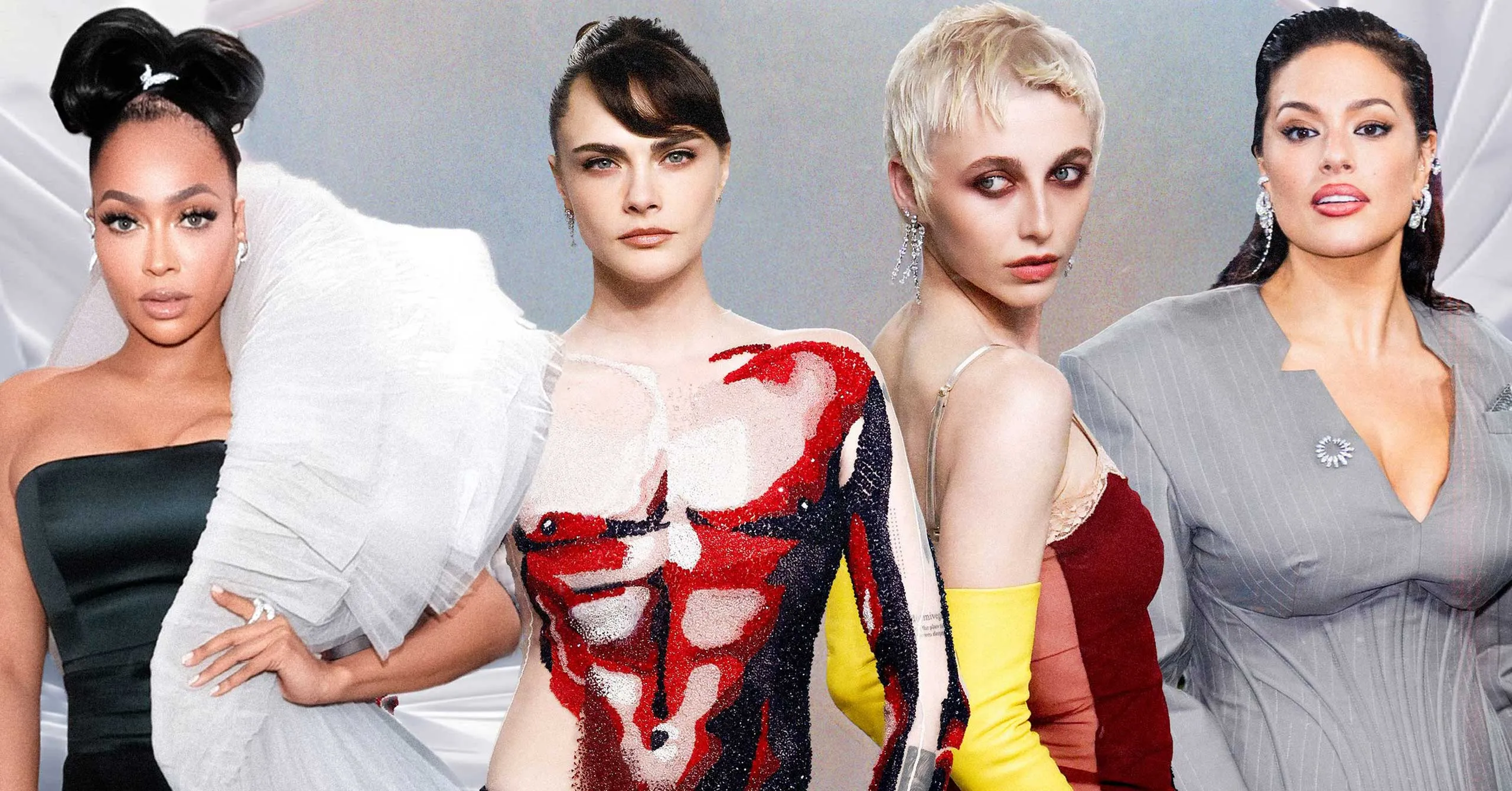 Group of four fashion models posing together in glamorous dresses for a shoot or runway backdrop.