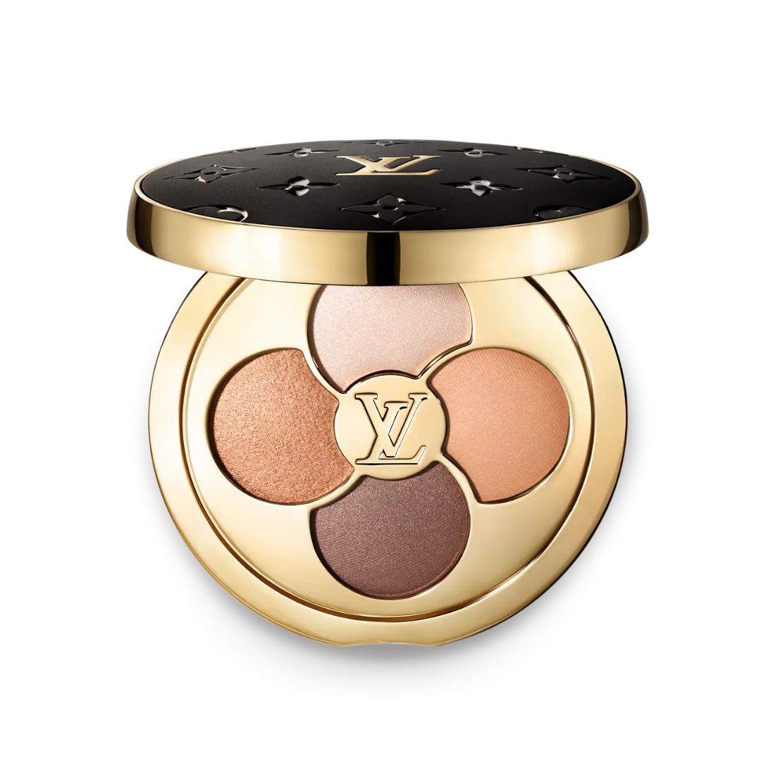 Gold circular makeup compact with four eyeshadow shades and a central LV logo, black lid with embossed patterns, set against a black background.