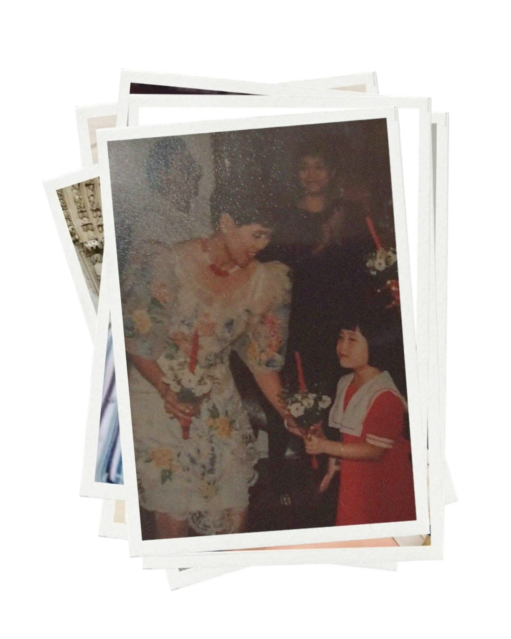 Stack of stacked photo prints, fanned out; one visible image shows a bride in a white dress holding a bouquet alongside another person in red.