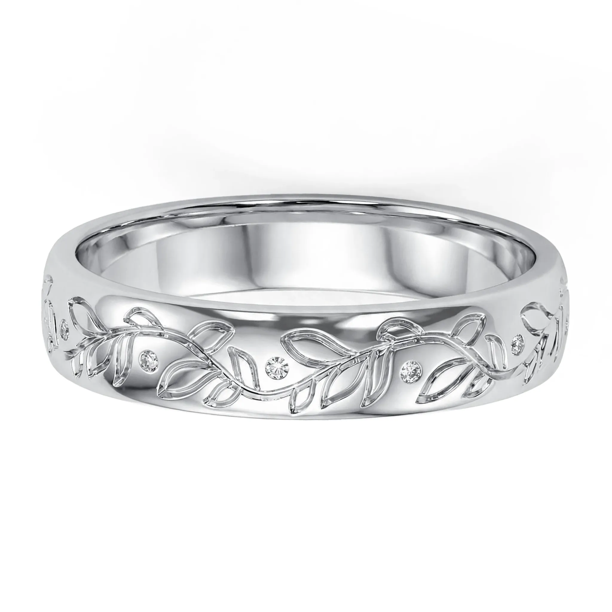 Close-up of a polished silver bowl featuring intricate scrolling vine designs and embedded crystals.