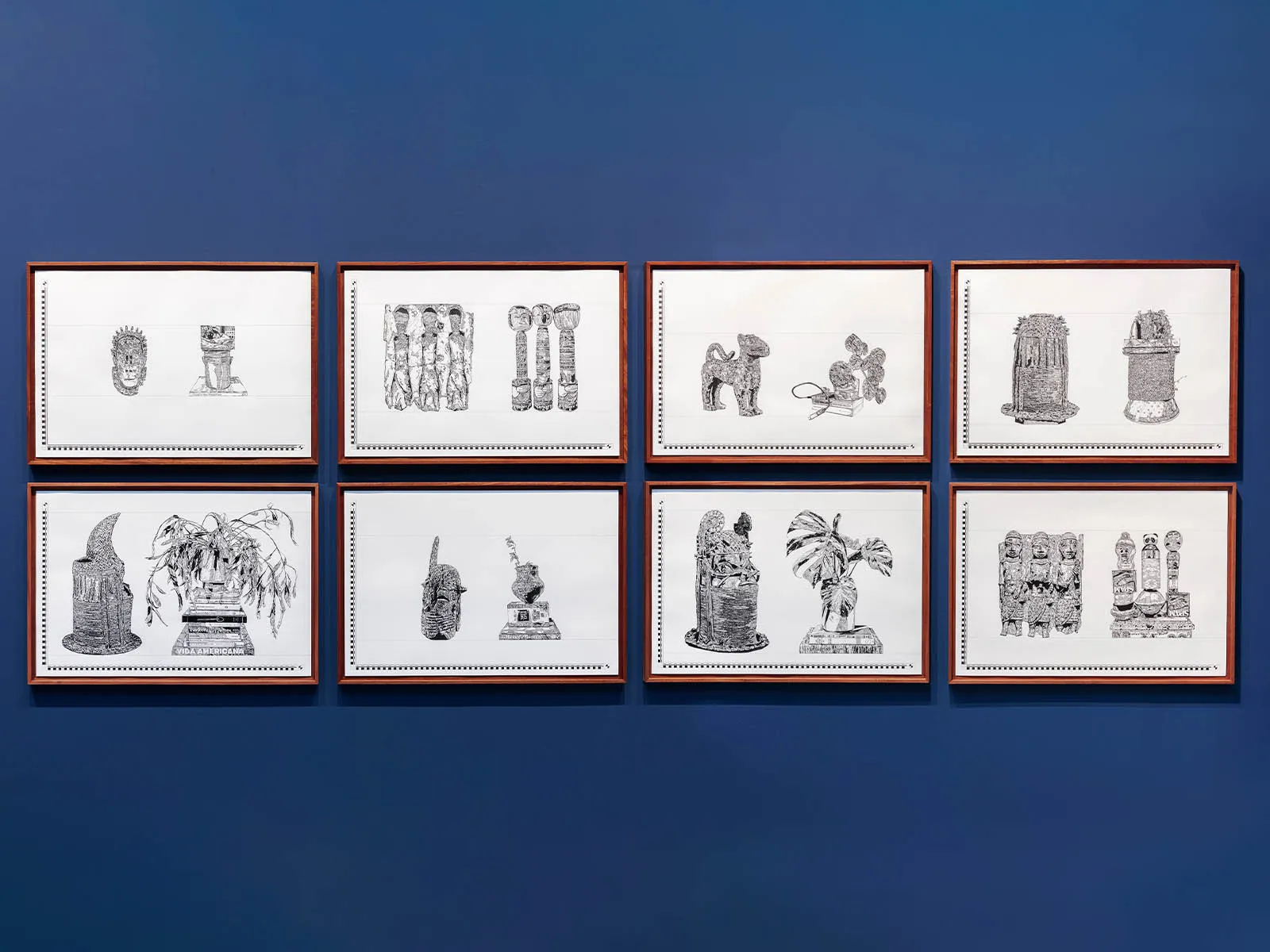 Eight framed black-and-white sketches arranged in two rows on a dark blue gallery wall.