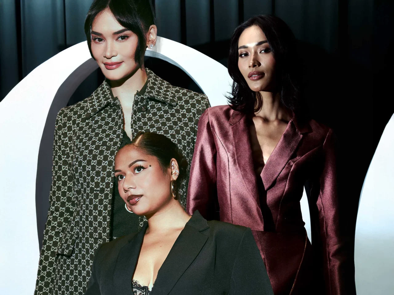 Three models pose in a fashion shoot: left in a brown patterned blazer, center in a burgundy satin suit, right in a black blazer.
