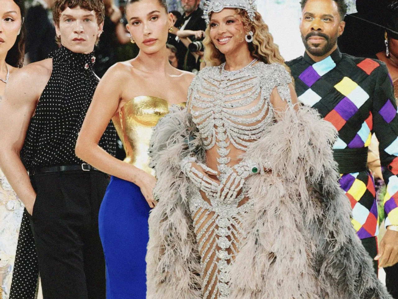 Group of celebrities posing together on a red carpet in glamorous, ornate outfits.