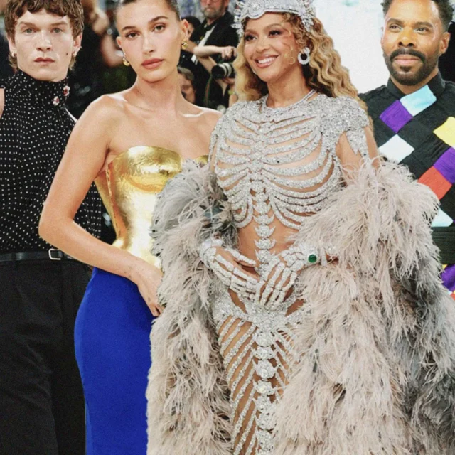 Celebrities posing on a red carpet in glamorous outfits, including a silver beaded dress centerpiece.