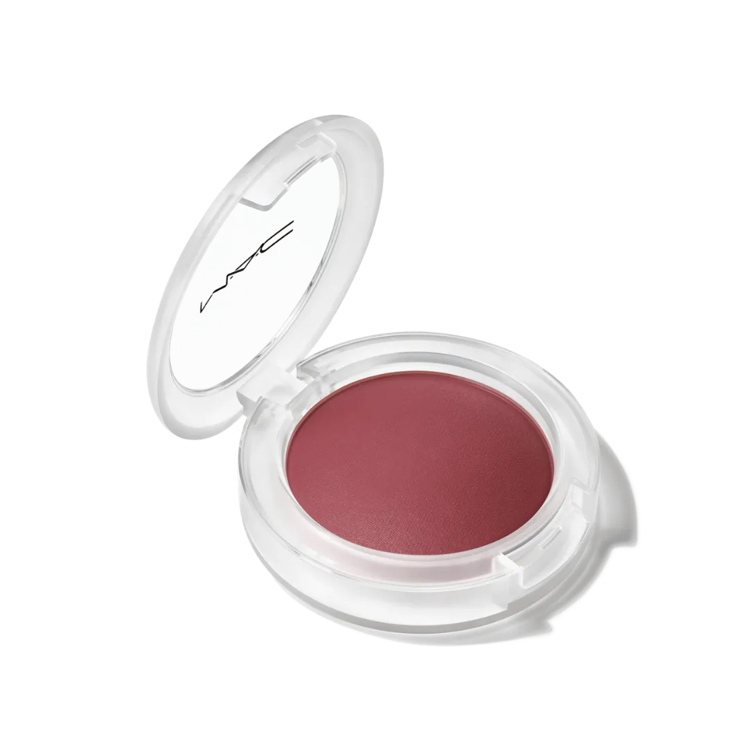 Clear round makeup compact with a mauve-pink blush inside and a white lid showing the MAC logo, open to reveal product.