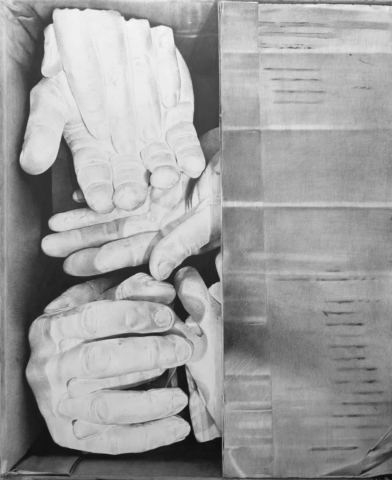 Monochrome sculpture of many stacked hands inside a cardboard box in grayscale.