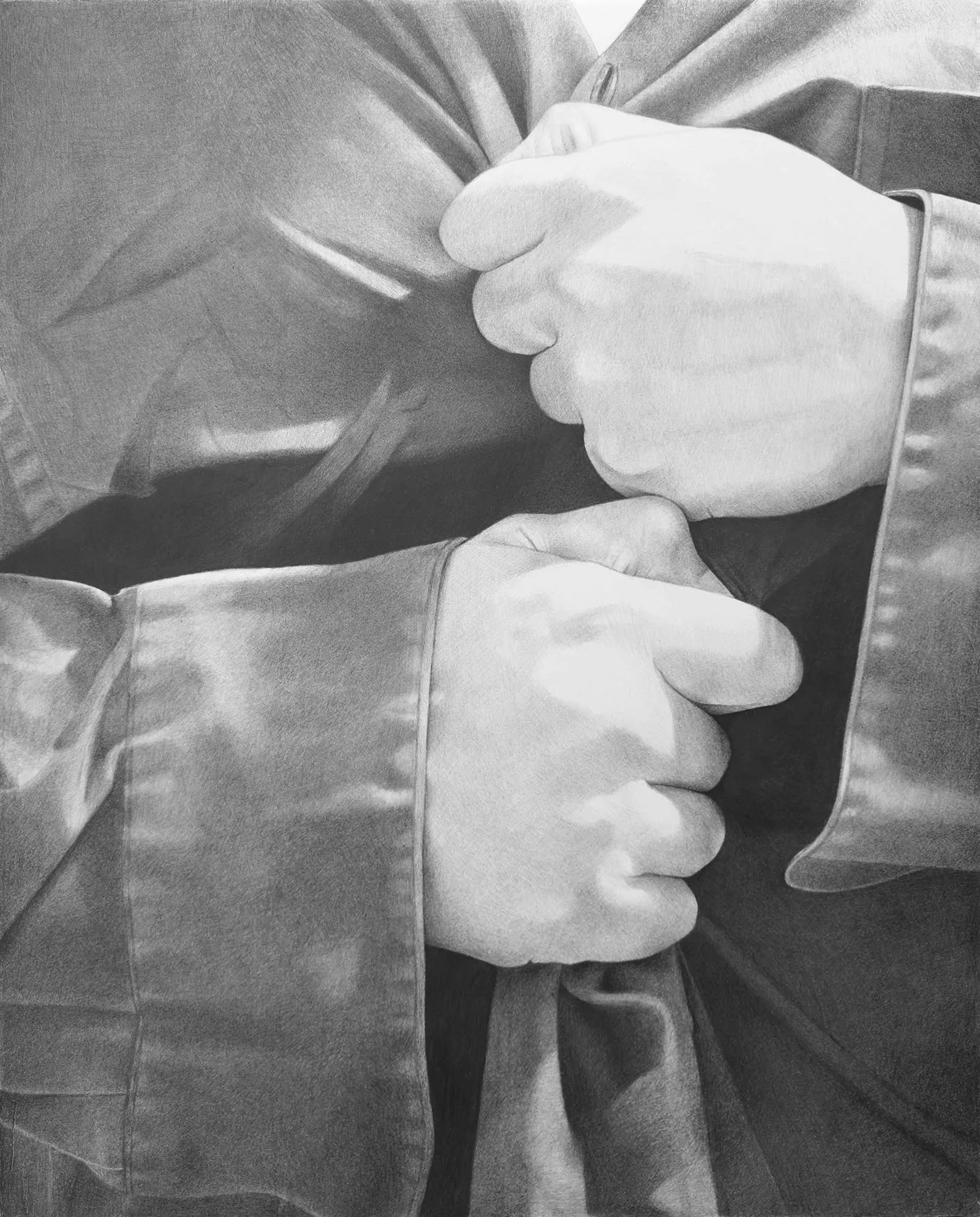 Close-up of hands adjusting a necktie on a suit jacket, showcasing formal attire.