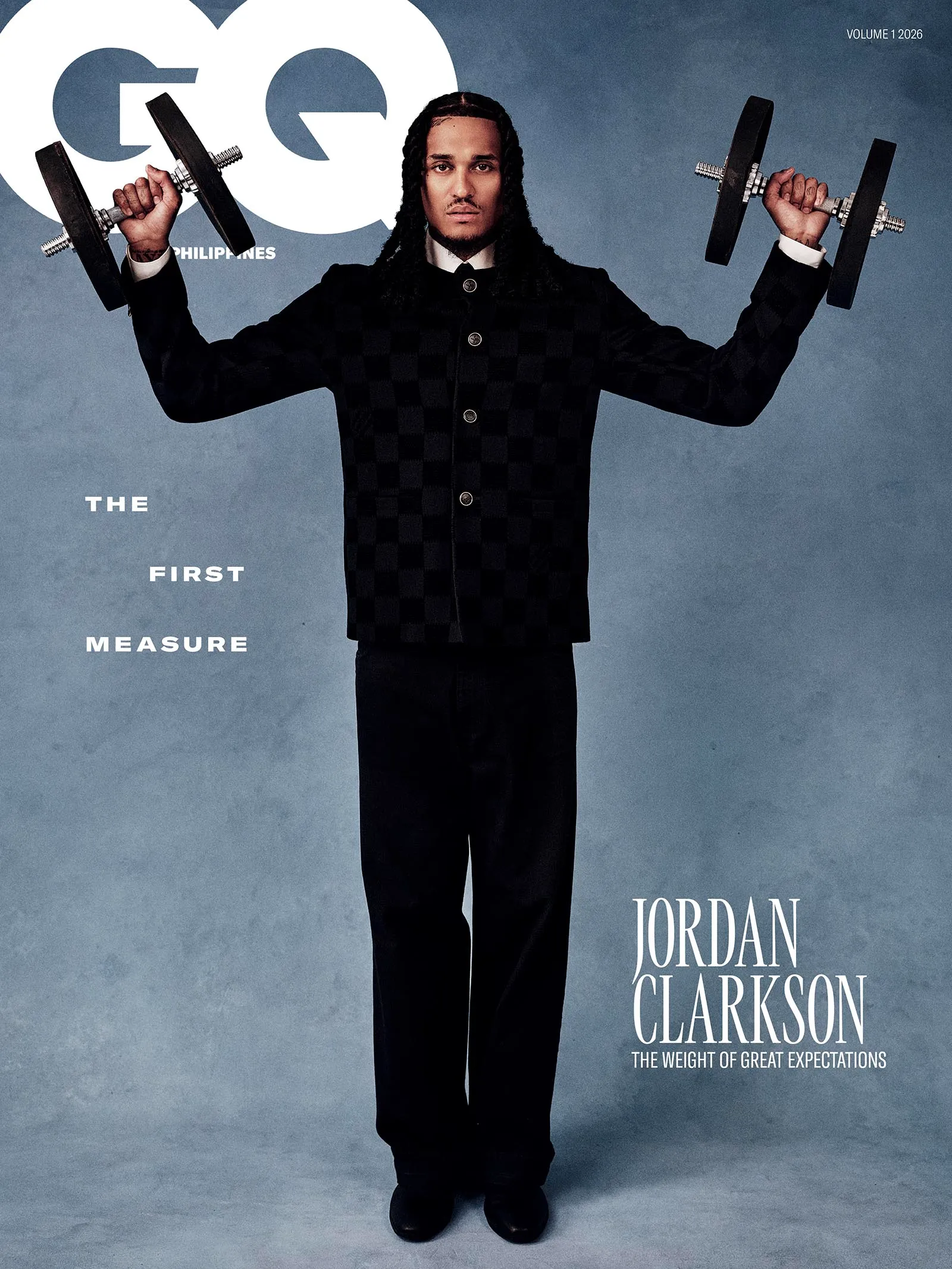 Portrait of Jordan Clarkson lifting dumbbells with both arms outstretched against a blue-gray backdrop; magazine cover text visible (GQ, The Weight of Great Expectations).
